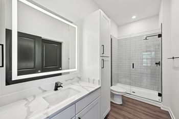 A modern bathroom with a white sink and a walk-in shower. at The Concord Luxury Apartments, Florida, 34240